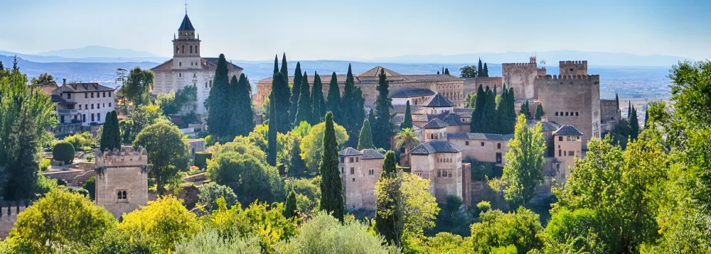 The Alhambra, a historic palace and fortress in Spain, showcasing intricate Islamic architecture and lush gardens.